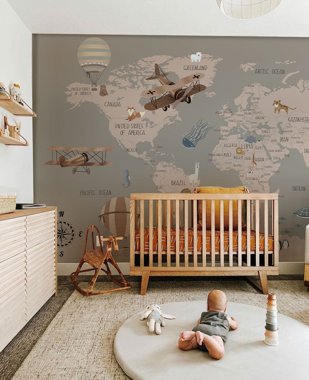 Wallpaper mural for the nursery featuring a grey and pink map.