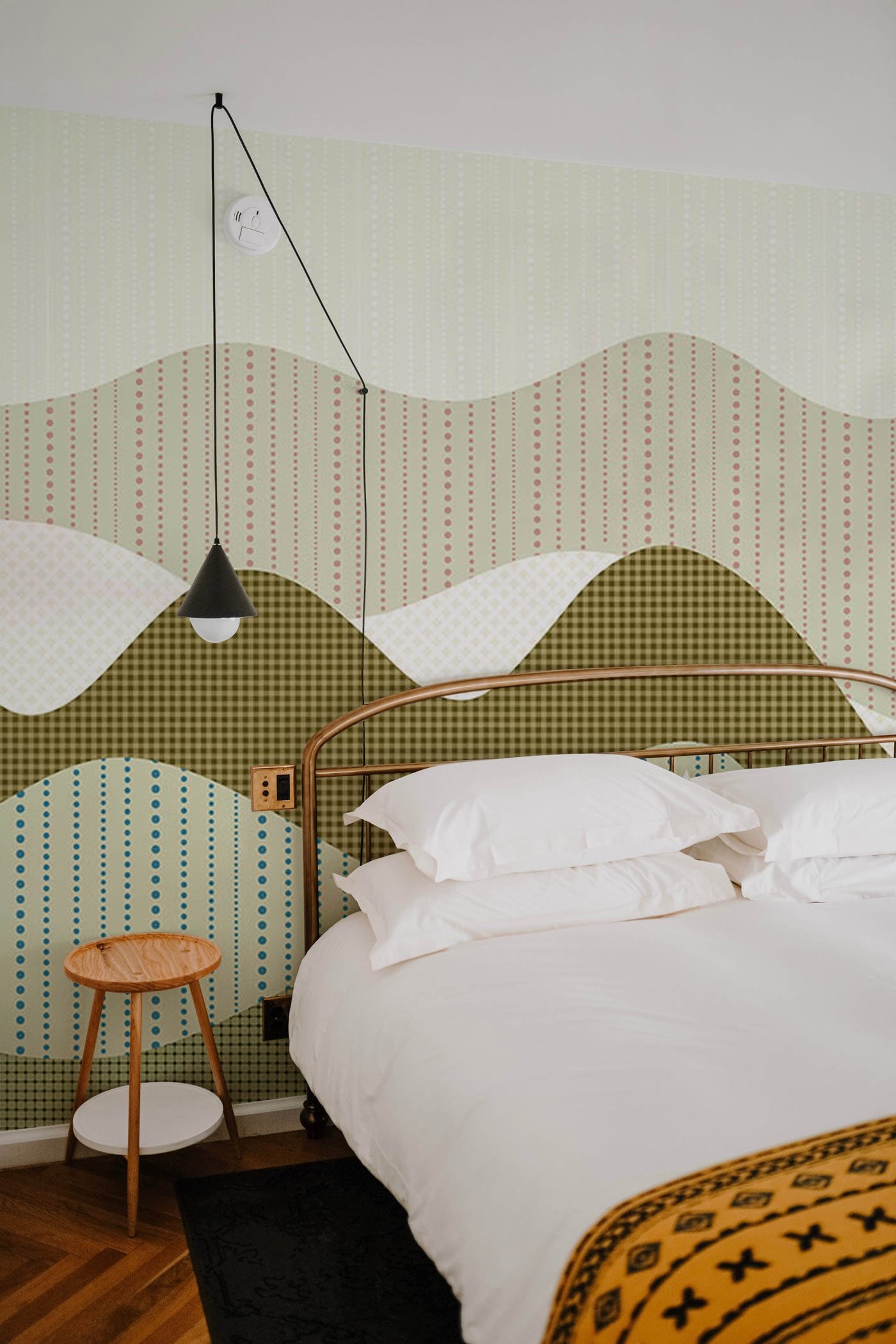 Wallpaper mural with a painted mountain scene for use in decorating a bedroom