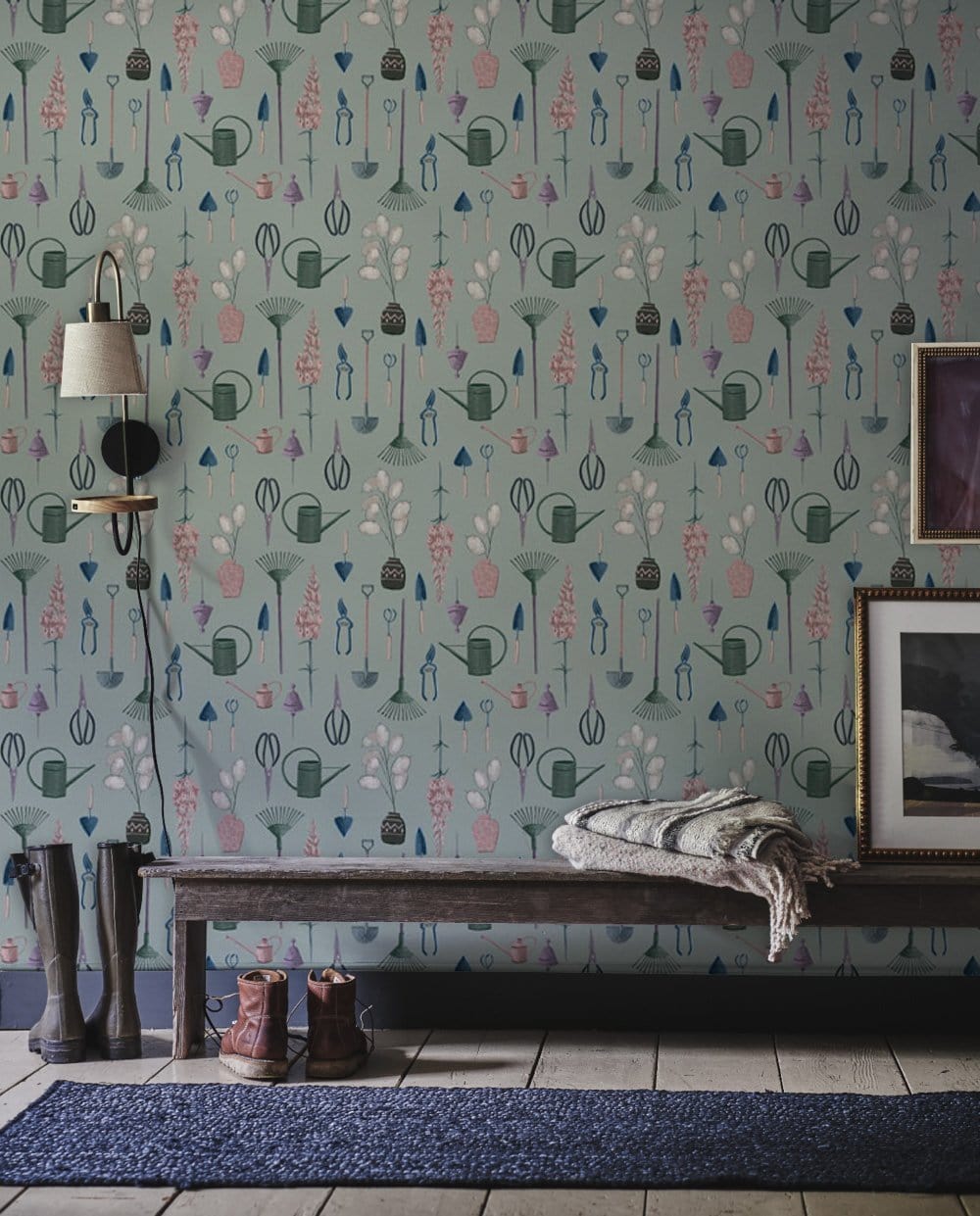 Wallpaper mural in the living room featuring a green flower and tools.
