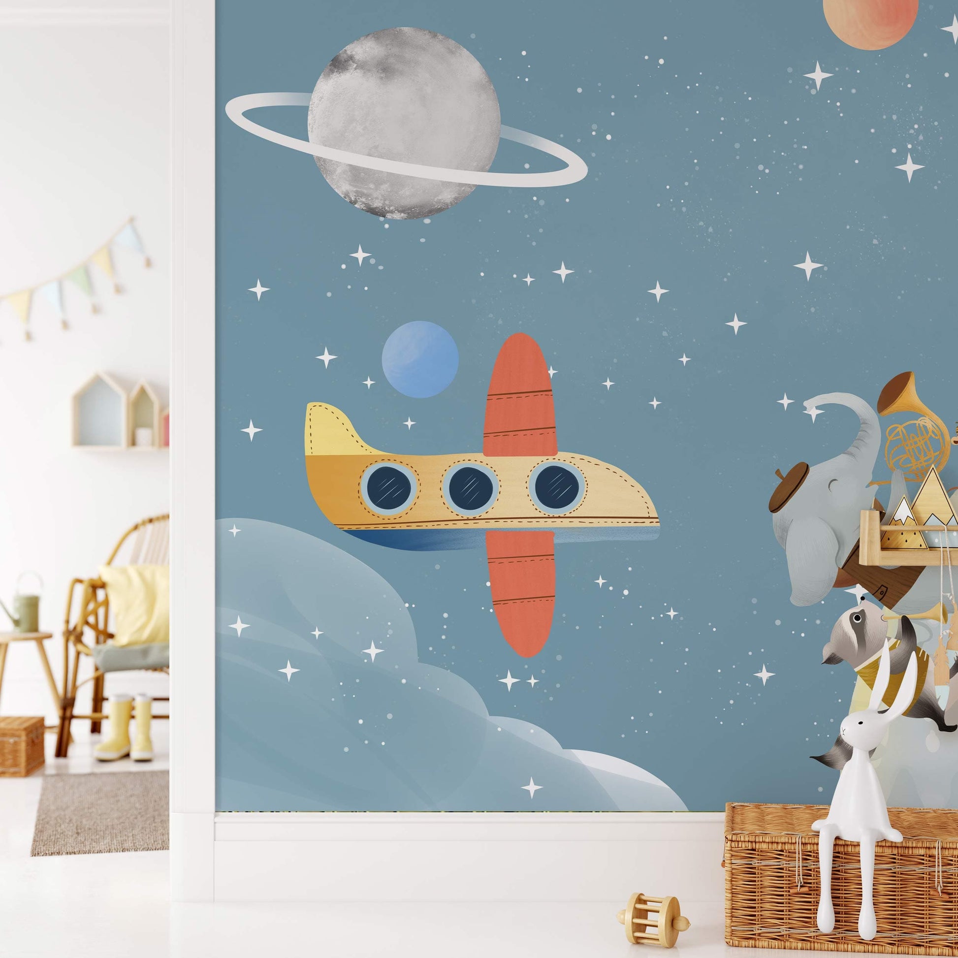 Wallpaper mural featuring roaming animals from the universe affixed to the walls of the nursery.