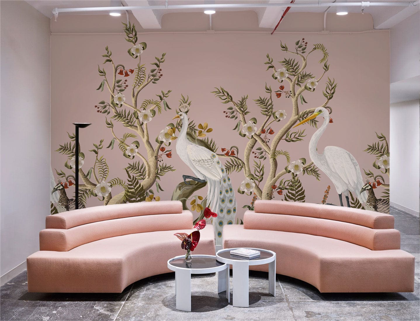Elegant Heron Botanical Mural Wallpaper with pink sofas in modern room, featuring soft pink and green tones.