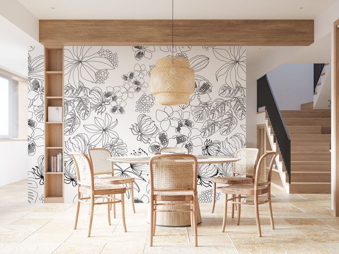 Monochrome floral wallpaper with rattan chairs, dining table, wicker pendant, and wooden shelving in modern room.
