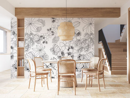 Monochrome floral wallpaper with rattan chairs, dining table, wicker pendant, and wooden shelving in modern room.