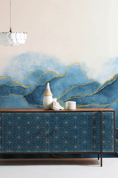 Wallpaper mural for the hallway decorated in a blue watercolour pattern with golden lines