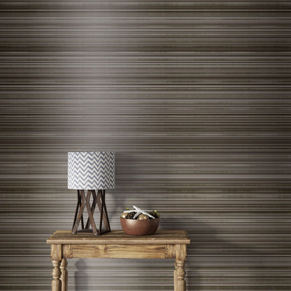 Elegant striped wallpaper in earthy tones, featuring wooden table and lamp in modern living room.
