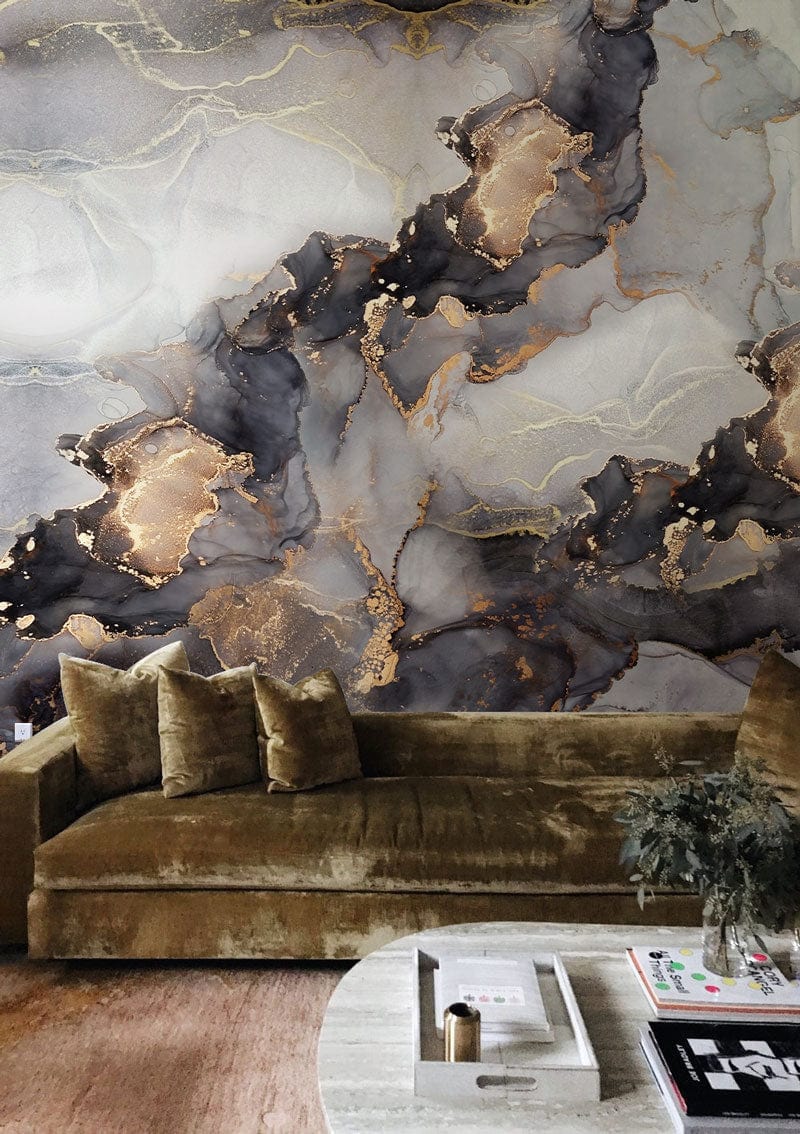 Luxurious gold and grey marble mural wallpaper in modern living room with velvet sofa and round table.