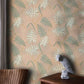 a wallpaper mural with pine leaves on a pink background for the bedroom