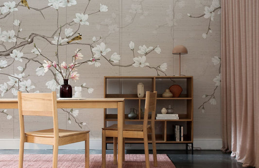 Elegant Blossom Beige Floral Mural Wallpaper with birds, wooden dining set, shelves, pink curtain, rug, lamp.