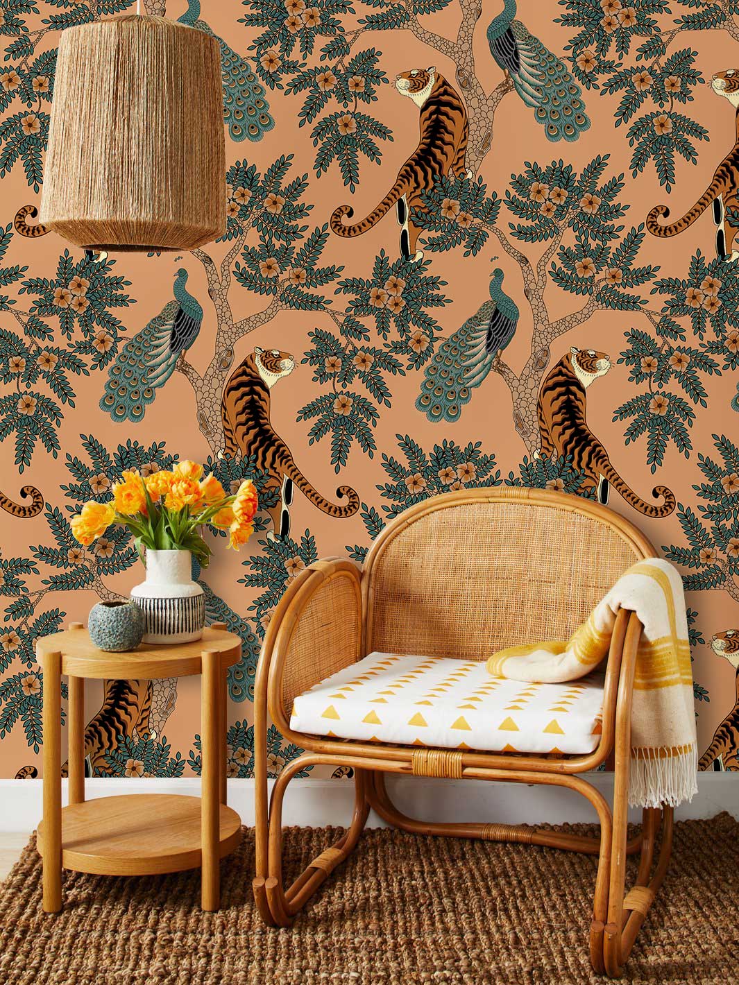 Vintage botanical fauna wallpaper in earthy tones, wicker chair, wooden side table, woven lampshade.