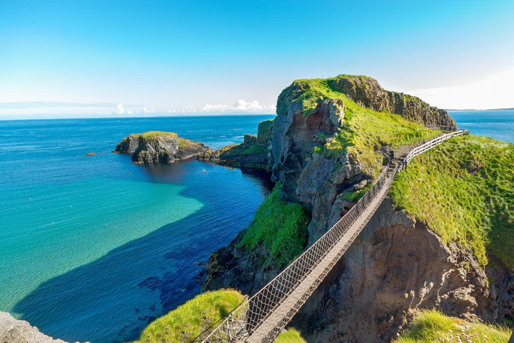 Wallpaper mural featuring a scene of the Carrick a Rede Rope Bridge for use in interior design.