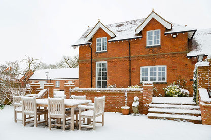 Wallpaper mural for home decoration featuring a red house with snow covering it.