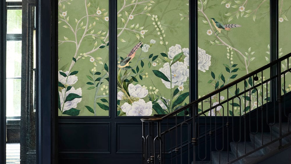 a traditional wallpaper mural in green with birds and flowers for a stairwell