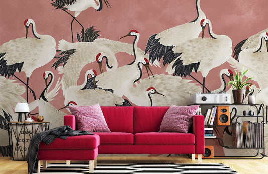 Wallpaper mural featuring cranes on a pink background, perfect for the living room.