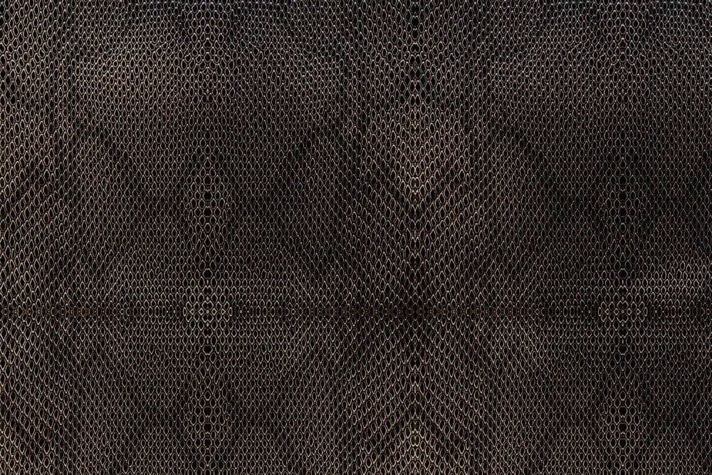 Wallpaper with a Dense Black Python Skin Texture and it is Applied on the Wall