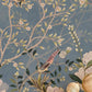 a blue wall painting of birds and flowers in a corridor