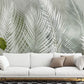 Wallpaper mural with feathers and leaves in green, perfect for decorating the living room.