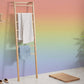 Wallpaper mural with an ombre cream and rainbow design, ideal for use in the bathroom.