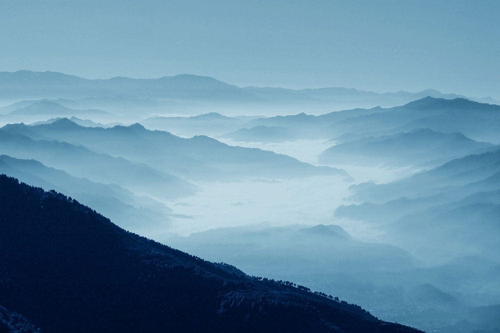 Wallpaper Mural of Rolling Misty Mountains for Use in Home Decoration