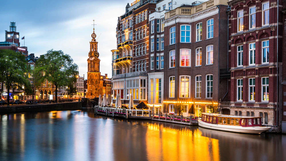 shops in Amsterdam by shore turn lights on early before dusk customized wallpaper