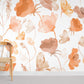 Mural room wallpaper in orange with watercolour floral designs.