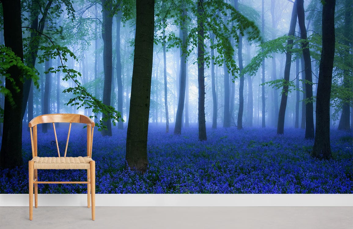 misty forest with blue flowers on the ground wallpaper for home