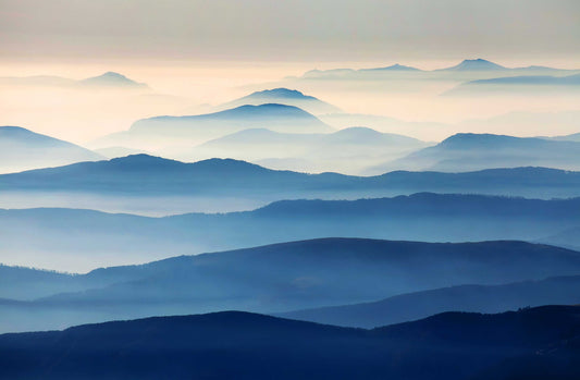 Wallpaper mural featuring blue mountains rolling in the distance, perfect for home decor.