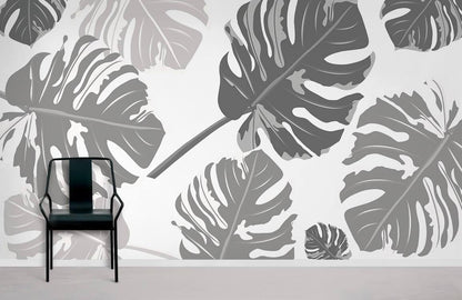 Wallpaper with a repeating pattern of large grey leaves, used for home decoration