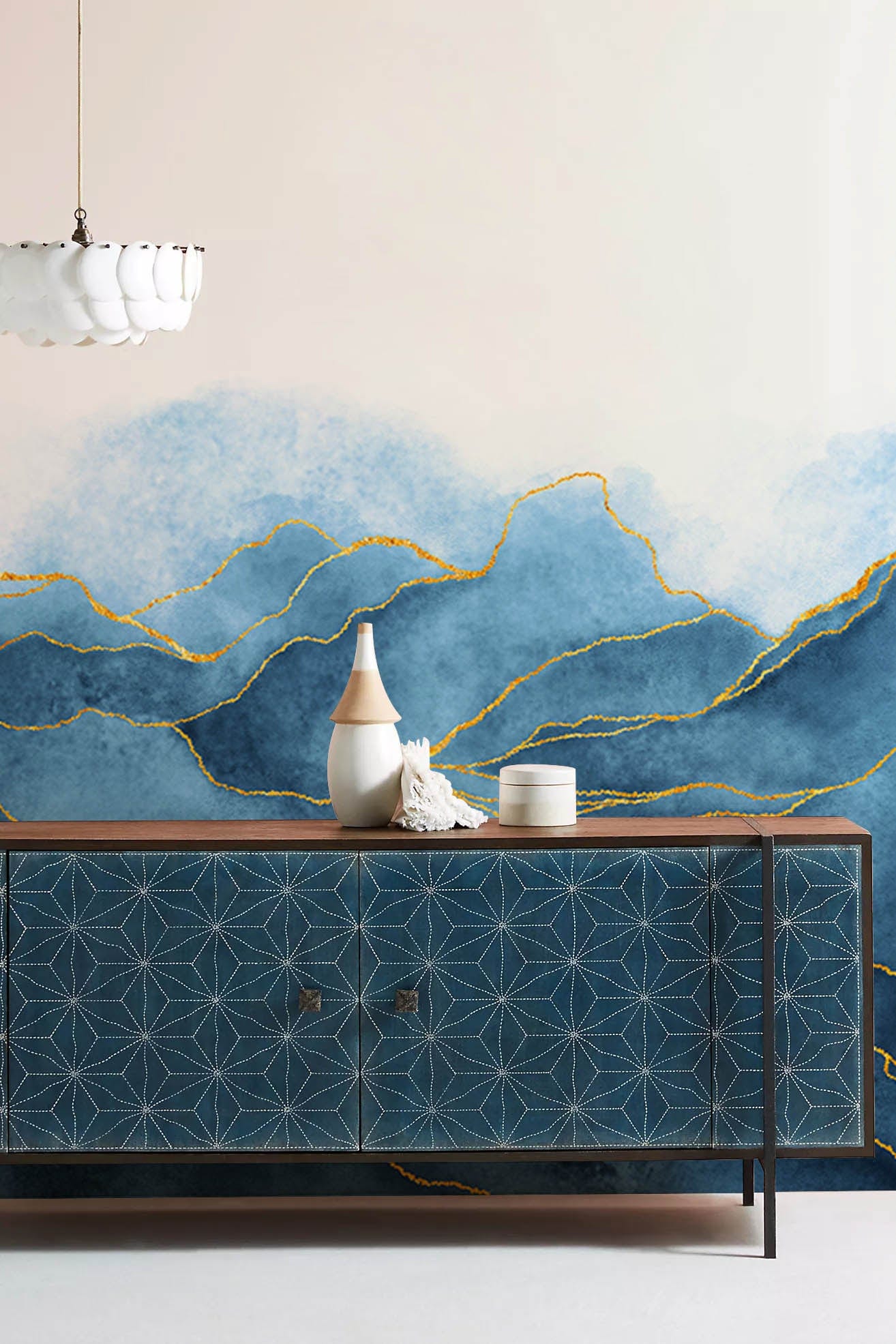 Wallpaper mural for the hallway decorated in a blue watercolour pattern with golden lines