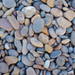Wallpaper mural with blue pebbles for use as home decor.