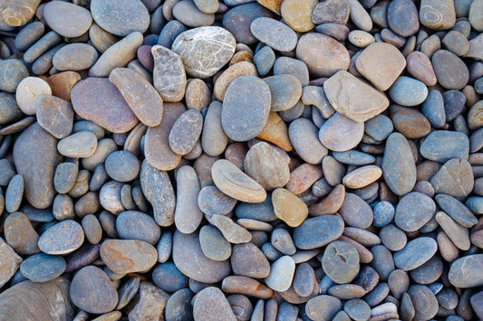 Wallpaper mural with blue pebbles for use as home decor.