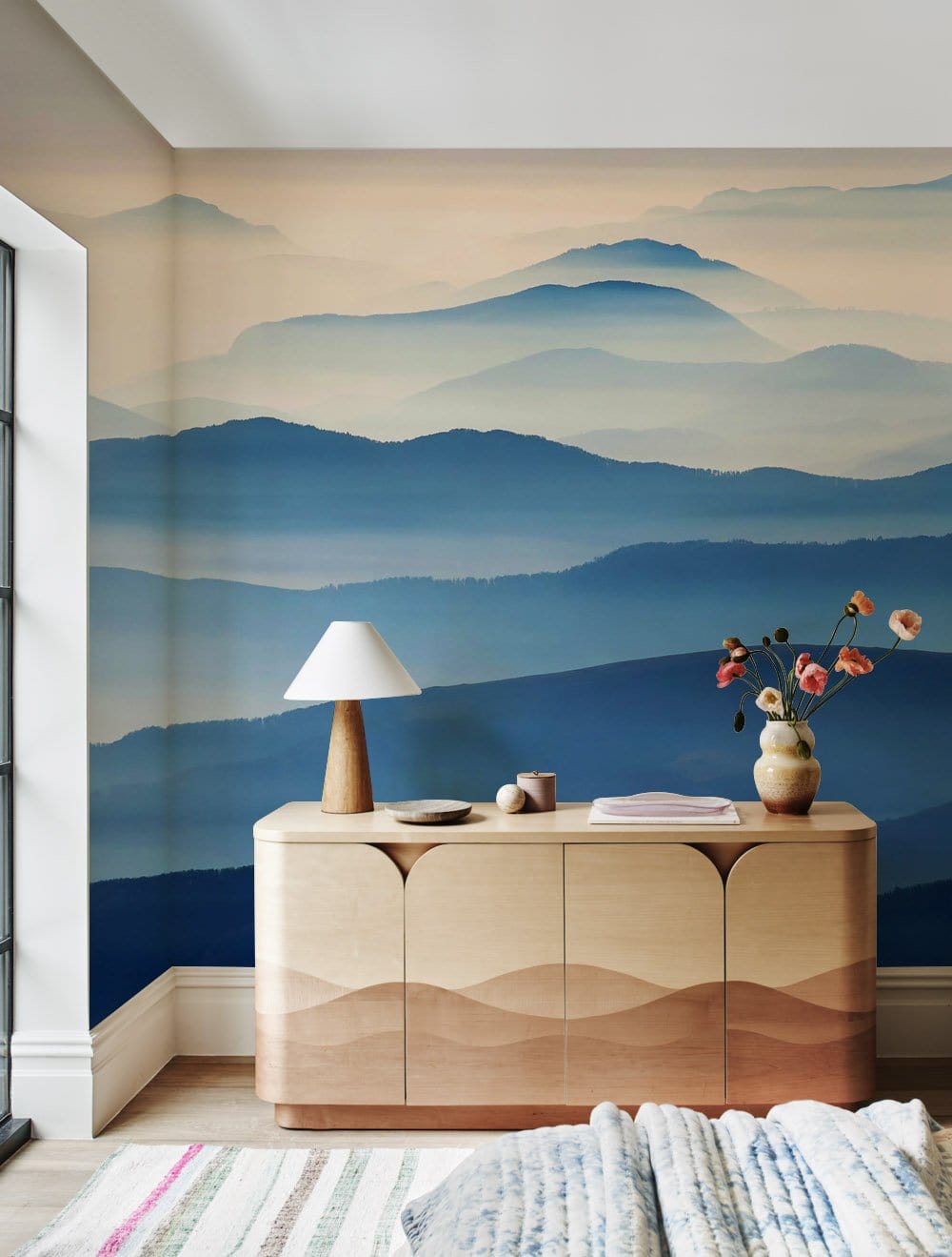 Wallpaper mural featuring blue rolling mountains, perfect for decorating the living room.