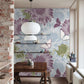 Design of retro wallpaper with a daisy blossom in green, blue, and purple as well as a white butterfly