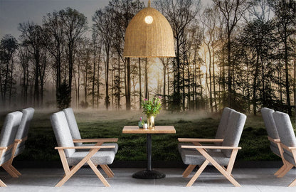 A dining room has a wall mural of a misty forest at dawn