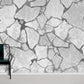 Wallpaper mural in grey with cracks for use as home decor.
