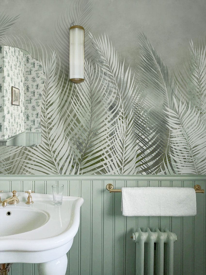 Wallpaper mural with feathers and leaves in green for use as bathroom decor.