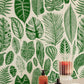 Wallpaper mural with tropical leaves in green for the hallway's decor.