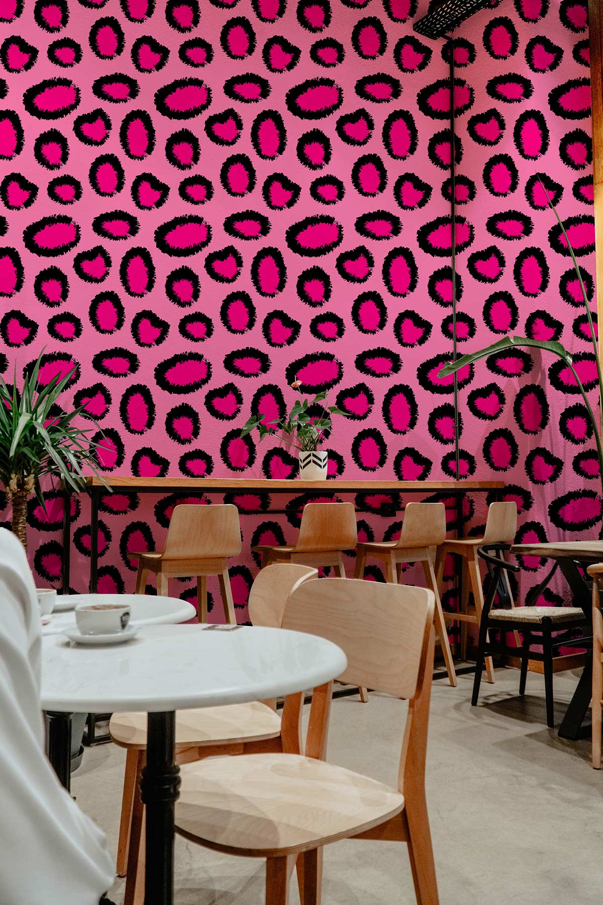 Wallpaper mural with a pink leopard print and animal skin pattern, intended for use in restaurants.