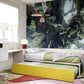 Wallpaper mural of a green forest scene inside a bedroom