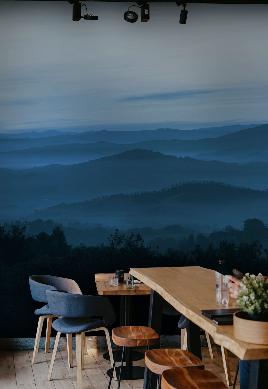 Wallpaper mural with ombre blue hilltops, perfect for decorating the dining space.