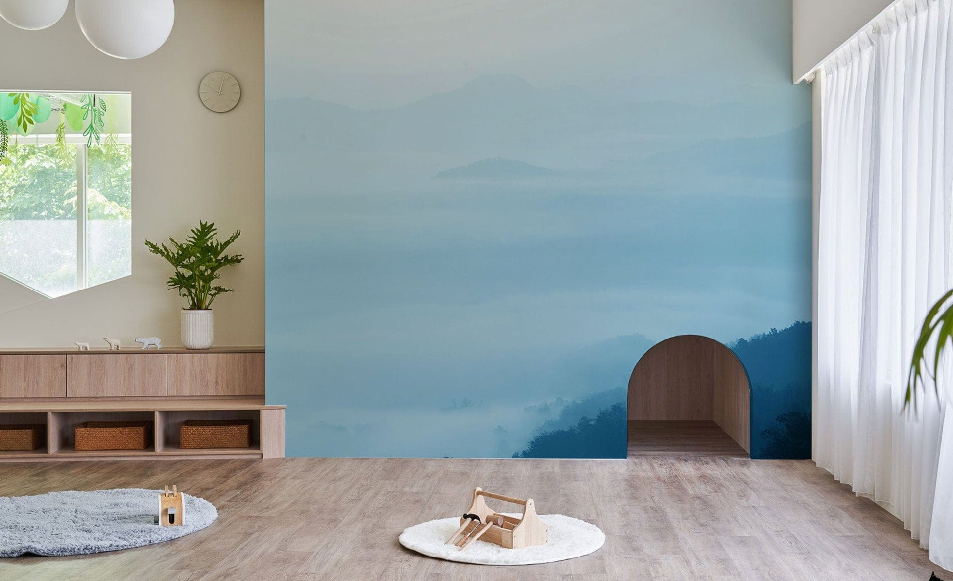 Decorate your living room with this ombre cloud and hilltop wallpaper mural.
