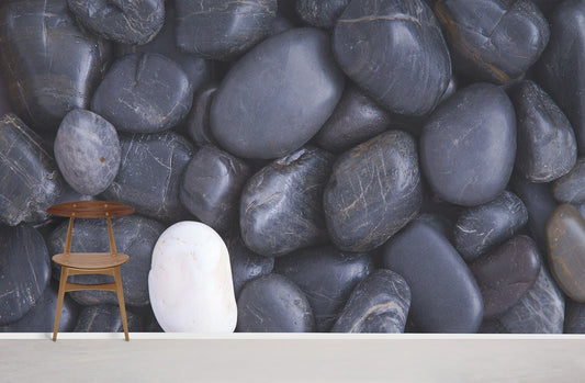 Wallpaper mural for home decoration with a white pebble embedded in a black pebble design.