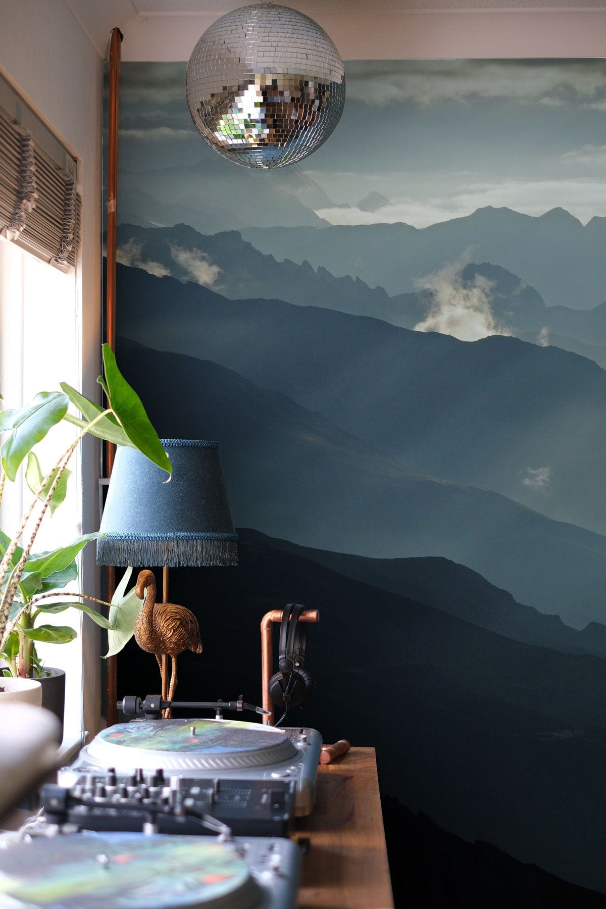 Wallpaper mural featuring a mountain range and landscapes, perfect for the entryway.