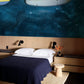Wallpaper mural featuring a shining dark ocean for use in decorating a bedroom