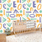 Wallpaper mural with a colourful letters pattern for use as decoration in the bedroom