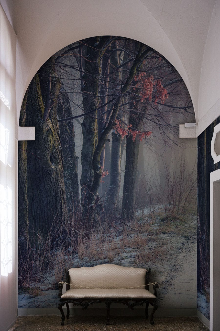 A snow-covered trail in the woods is shown on a wallpaper mural for a hallway