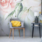 Wallpaper with a mural depicting spring flowers; pastel pink furnishings and accessories