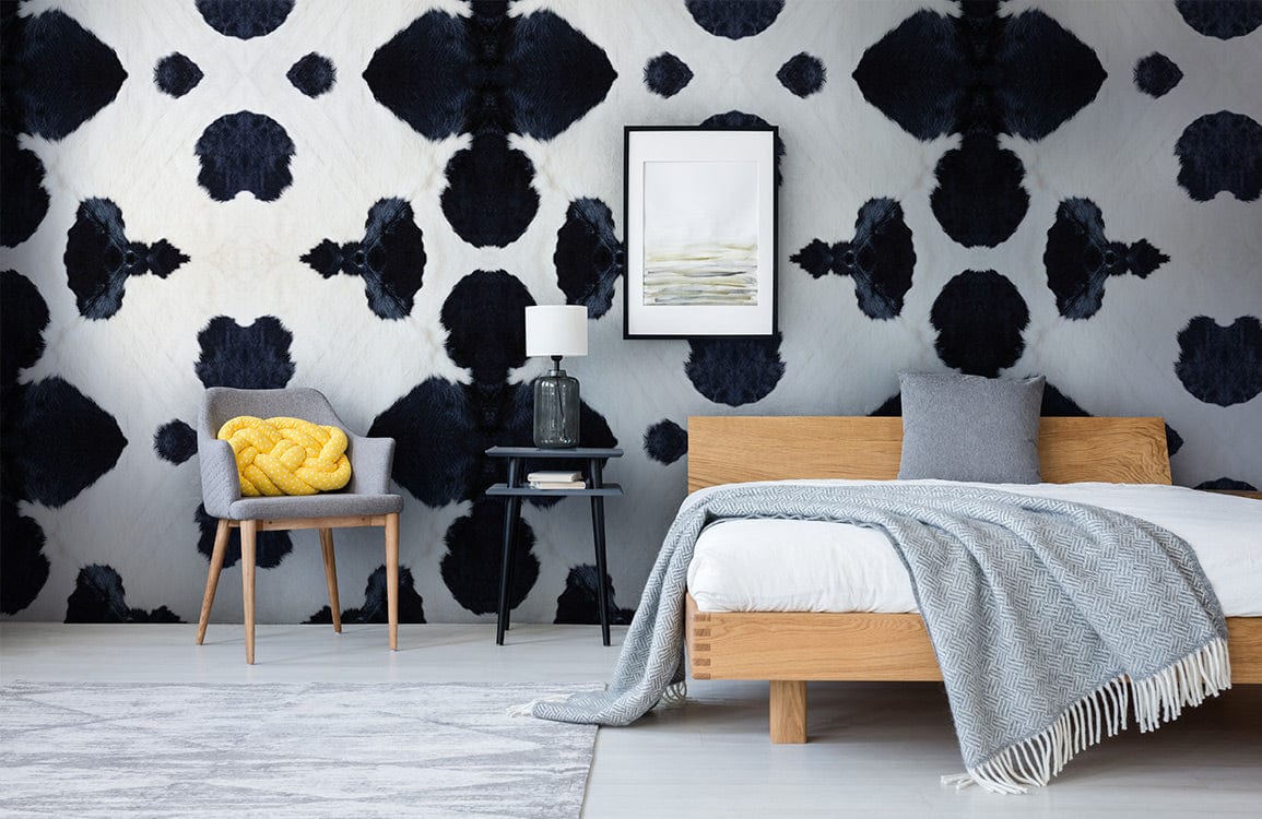 A wallpaper mural with the texture of milk cow skin is utilised for the d��cor of the bedroom.
