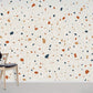 Terrazzo wallpaper with specks of pastel colour.