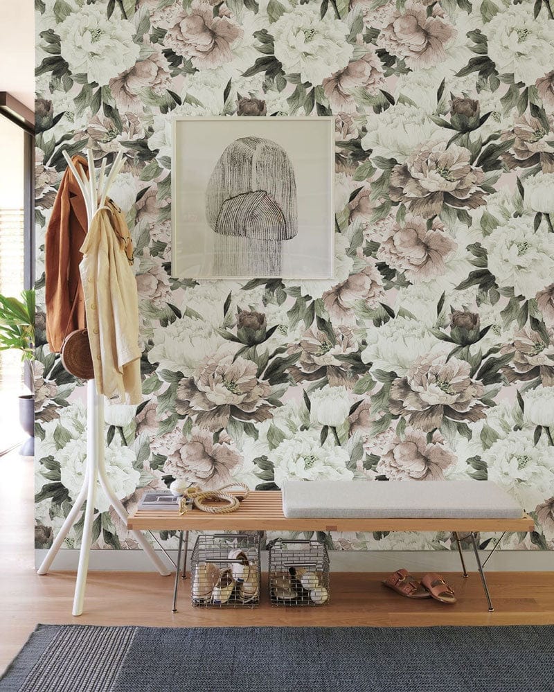 Flowers in white and muted tones are shown on a mural wallpaper that is located in a hallway.