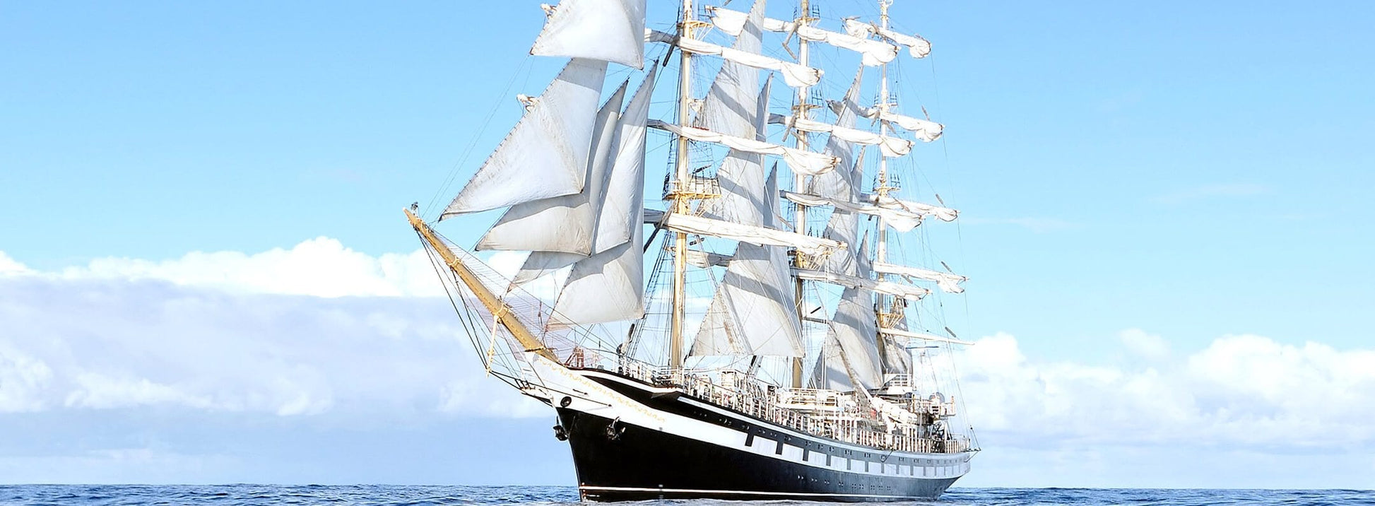 Wallpaper mural with a white ship and a blue sky for use in home decoration